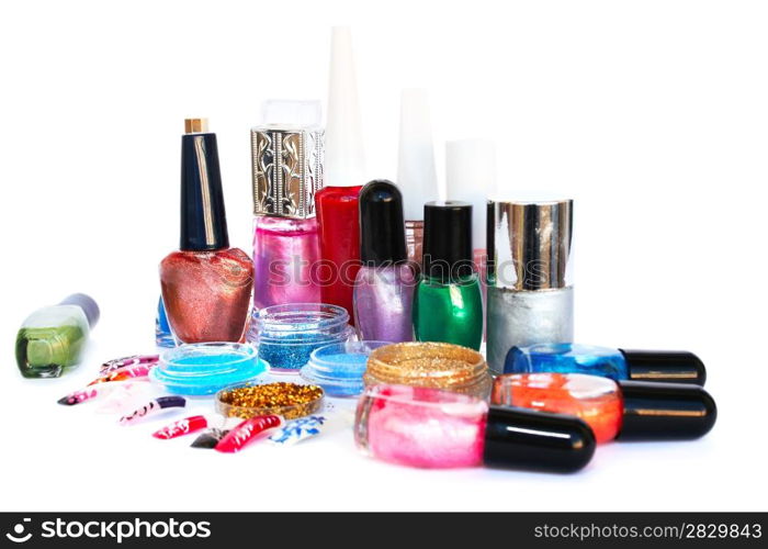 Nail polishes, glitters and nail figures isolated on white background.