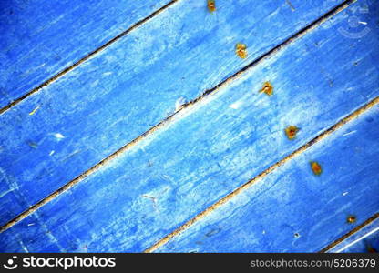 nail stripped paint in the blue wood door and rusty