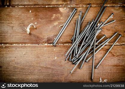 Nails on the table. On a wooden background. High quality photo. Nails on the table. On a wooden background.