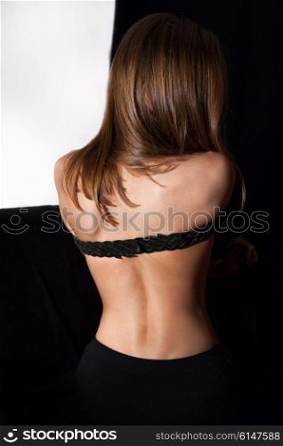 Naked back of beautiful young woman with long hair
