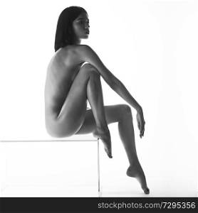Naked body of young sexy woman with beautiful figure. art photosession with black shadows on nude model. Erotic modern portraits of sensuality girl with perfect figure. white background.