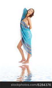 naked girl with blue sarong on white sand