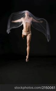 naked gymnast jumping with transparent cloth