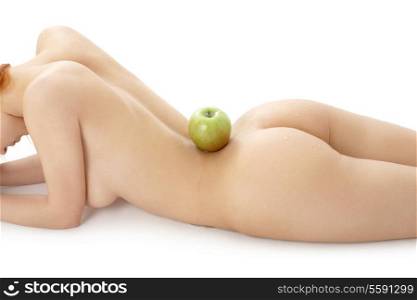 naked redhead with green apple on her spine over white