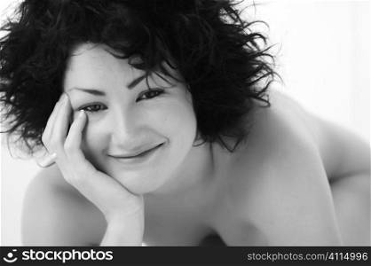 Naked woman smiling up at camera