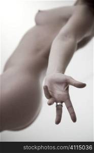 Naked woman with hand outstretched