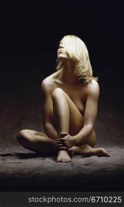 Naked young woman sitting