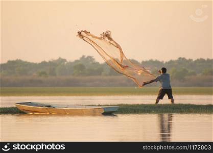 NAKHON PHANOM, THAILAND - Nov 4, 2018 : Fisherman casting a net into the lake