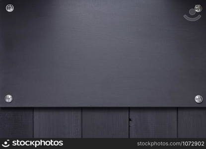 nameplate at black wooden background texture surface, with screws