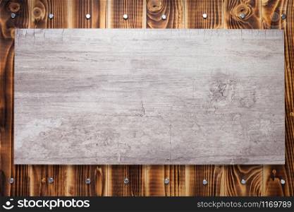 nameplate or wall sign at black wooden background texture surface, with screws