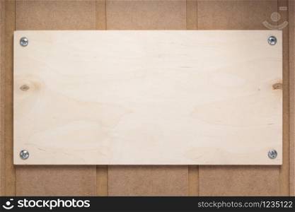 nameplate or wall sign at wooden mdf boards background as texture surface