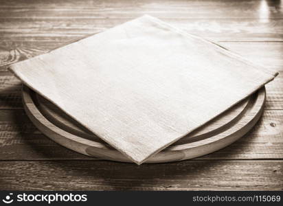 napkin at cutting board on wooden background