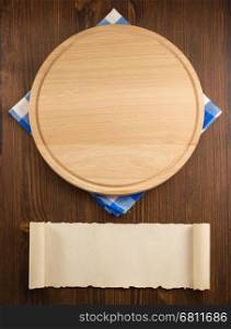 napkin cloth and cutting board on wooden background
