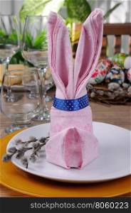 Napkin folded as an Easter bunny on a plate