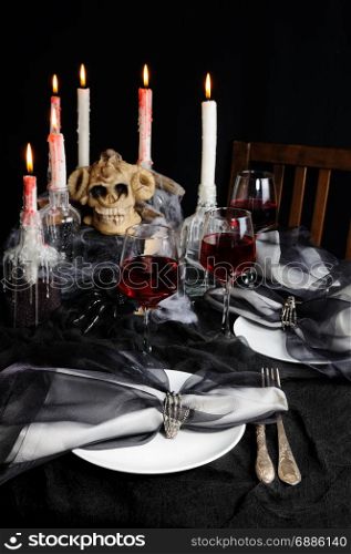 Napkin with a clip in the form of a skeleton of a brush as an element of a decor of a holiday table for Halloween