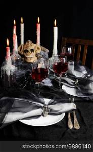 Napkin with a clip in the form of a skeleton of a brush as an element of a decor of a holiday table for Halloween