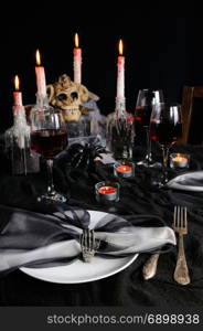 Napkin with a clip in the form of a skeleton of a brush as an element of a decor of a holiday table for Halloween