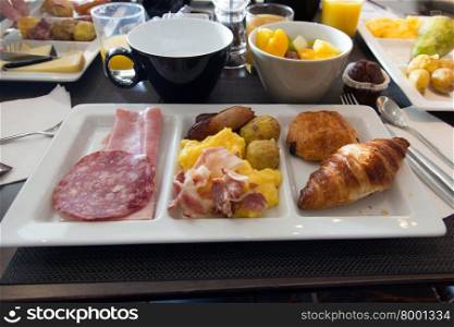 Napkin with extensive breakfast - meat - egg - pastry