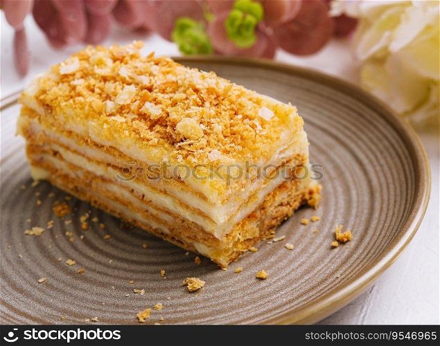 Napoleon cake on plate on table close-up