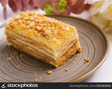 Napoleon cake on plate on table close-up