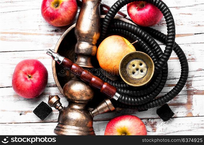 Nargile with apple. Smoking smoking shisha in east style with tobacco aroma of red apple.Apple hookah