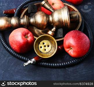 Nargile with apple. Smoking smoking shisha in east style with tobacco aroma of red apple.Apple hookah