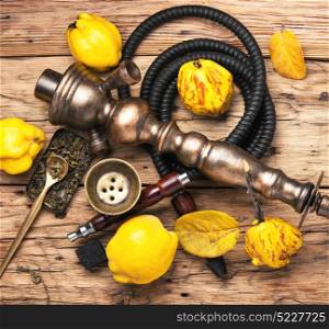 Nargile with quince. Smoking smoking hookah in Arabic style with the tobacco aroma of ripe quince