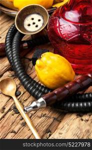 Nargile with quince. Smoking smoking hookah in Arabic style with the tobacco aroma of ripe quince