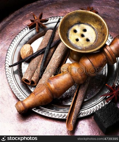 Nargile with spices. Smoking Turkish hookah with a taste of spices, cinnamon, tubby, vanilla