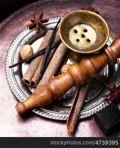 Nargile with spices. Smoking Turkish hookah with a taste of spices, cinnamon, tubby, vanilla