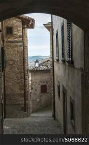 Narrow alley by houses in town, Radda in Chianti, Tuscany, Italy