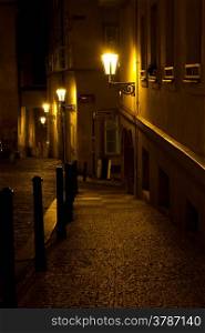 Narrow alley with lanterns in Prague at night , Czech Republic .
