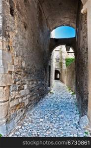 Narrow Alley with Old Buildings in French City of Viviers