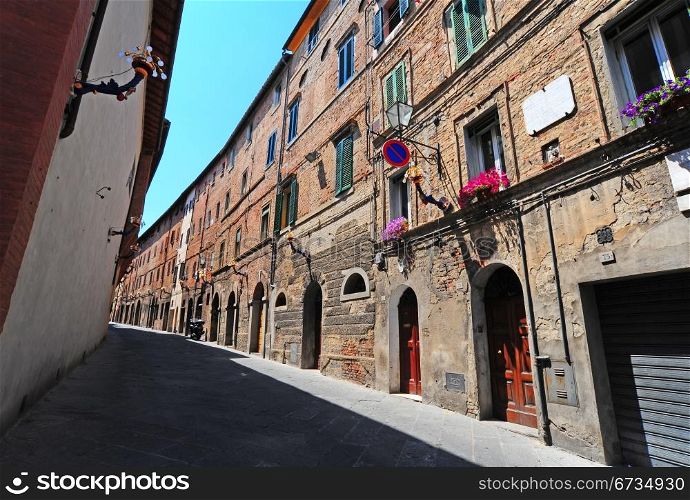 Narrow Alley With Old Buildings In Italian City of Siena