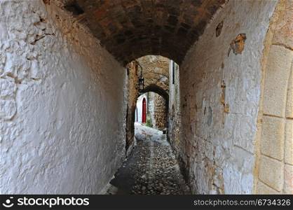 Narrow Alley With Old Buildings In Typical Greek City