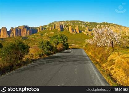 Narrow, asphalt winding road leading to a delightful canyon in Spain. Retro style