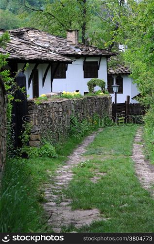 Narrow back street in Bozhentsi village in Bulgaria