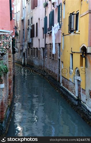Narrow canal in Venice on a gray day