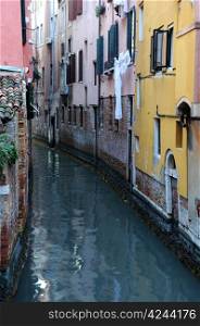 Narrow canal in Venice on a gray day