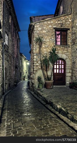 Narrow cobbled street in the old village Tourrettes-sur-Loup at night, France.