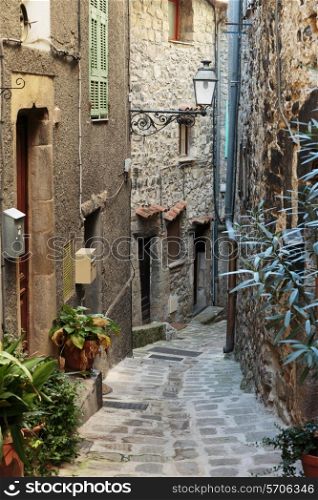 Narrow cobbled streets with flowers in the old village Gourdon, France