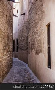 Narrow deserted street in the old city of Dubai. Narrow deserted street in the old city of Dubai UAE
