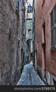 Narrow medieval street in France. Toned