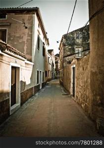 Narrow mediterranean street in Dalmatia , Island of Susak, Croatia - vertical
