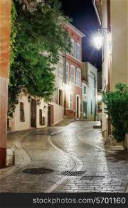 Narrow old street at night in Saint-Tropez, France.