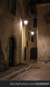 Narrow old street at night in Saint-Tropez, France.