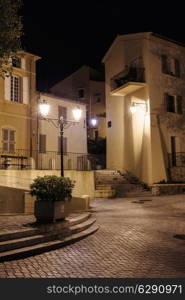 Narrow old street at night in Saint-Tropez, France.