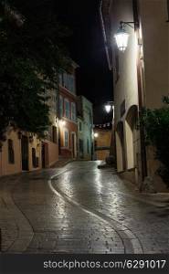 Narrow old street at night in Saint-Tropez, France.
