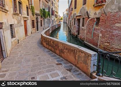 Narrow old street Canal in Venice Italy