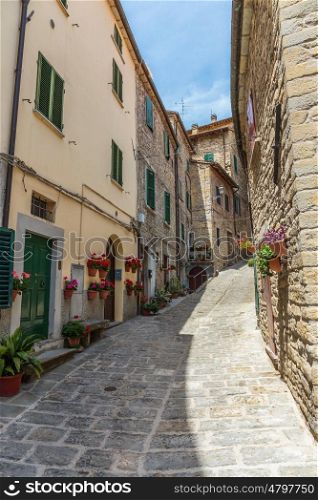 Narrow old street with flowers in Italy